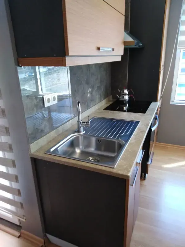 Integrated kitchen equipped with sink and modern work surfaces